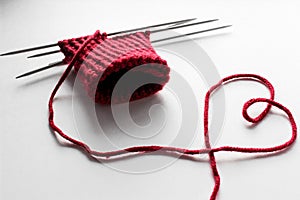 Unfinished wool and knitting needle design. Red thread and tangle. Handmade concept. Craft banner. Love, romantic, valentines day