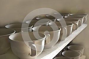 Unfired Pottery Cups in a Row