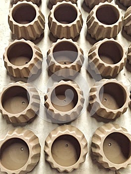 Unfished clay pots wait for burning process in pottery factory.
