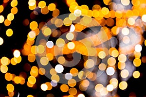 Unfocused abstract gold bokeh on black background. defocused and blurred many round light