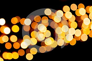 Unfocused abstract gold bokeh on black background. defocused and blurred many round light