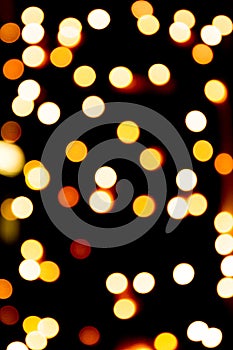 Unfocused abstract gold bokeh on black background. defocused and blurred many round light