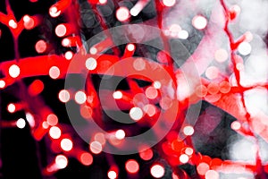 Unfocused abstract red bokeh on black background. defocused and blurred many round light