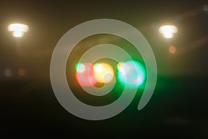 Unfocused night shot of Christmas garland lights bokeh in the city. Happy New Year, Merry Christmas, winter holidays