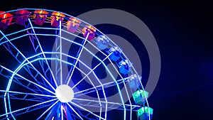 Night photo of a moving illuminated Ferris wheel in Madrid, Spain photo