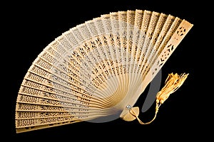 Unfolded ancient fan isolated on black photo