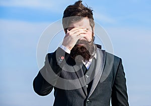 Unforgivable mistake. Business failure. Man bearded stressful painful face sky background. Guy suffer headache stressful