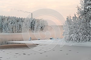 Unfrozen lake in the winter forests