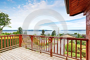 Unfurnished and empty balcony with perfect water view and wooden railings