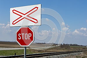 Unguarded railway crossing in a rural landscape