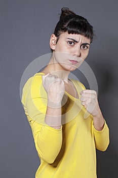 Unhappy 20s woman showing her fists for self-defense
