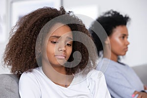 Unhappy African American teen girl having problem with strict mother