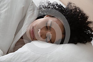 Unhappy African American woman suffering from nightmare, lying in bed