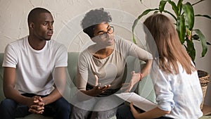 Unhappy african wife talking to psychologist complaining on bad relationship