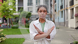 Unhappy Angry African American Woman Gesturing Stop to the Camera Outside.