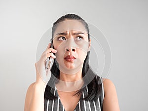 Unhappy and angry woman talking on smartphone.