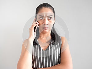 Unhappy and angry woman talking on smartphone.