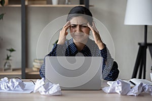 Unhappy annoyed Indian business woman feeling strong headache