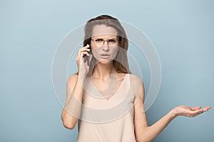 Unhappy annoyed woman talking on phone, hearing bad news