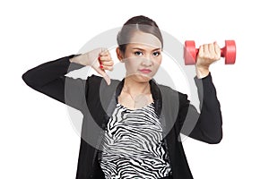 Unhappy Asian business woman thumbs down with dumbbells