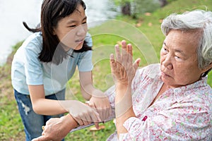 Unhappy asian child girl comfort upset offended senior grandmother,female teenager is stressed to trying to reconcile or