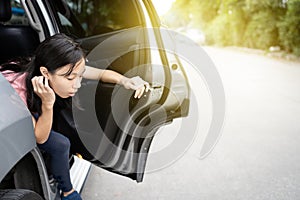 Unhappy asian child girl about to throw up from car sick or indigestion,female teenage vomiting in a car suffers from motion photo