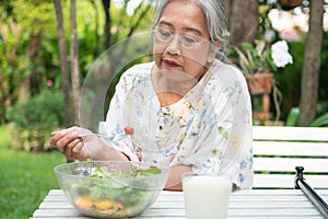 Unhappy Asian senior woman anorexia and say no to meals, Elderly home alone and bored food and no appetite, Concept of healthcare