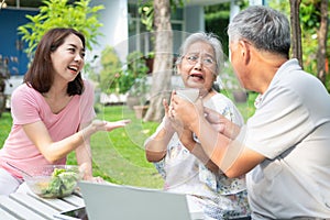 Unhappy Asian senior woman anorexia and say no to meals, Elderly live with family and caregivers try feed food and old woman no