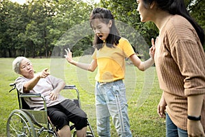 Unhappy asian teen granddaughter dissuade her family from a fight something money,angry senior mother and daughter arguing