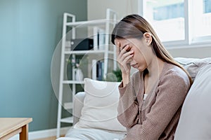 Unhappy asian woman sitting alone. Sad woman have mental symptoms illnesses and depression. stress, unhappy, pain