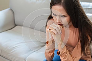 Unhappy asian woman sitting alone. Sad woman have mental symptoms illnesses and depression. stress, unhappy, pain