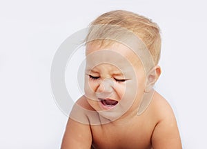 Unhappy baby child isolated over white