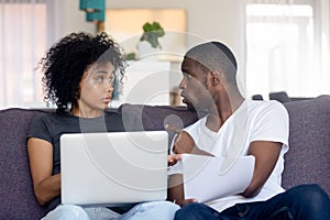 Unhappy black couple dispute having disagreement on family expenses