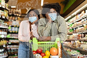 Unhappy Black Couple Shopping In Supermarket Struggling During Financial Crisis