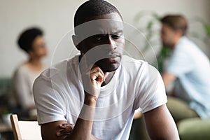 Unhappy black male loner feel hurt sitting alone photo