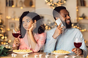 Unhappy Black Woman Bored On Date, Man Talking On Phone