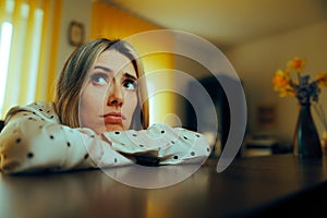 Unhappy Bored Receptionist Waiting for New Guests in a Hotel