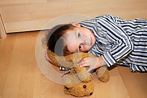 Unhappy boy and his cuddly toy