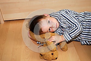 Unhappy boy and his cuddly toy photo