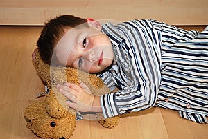 Unhappy boy and his cuddly toy photo