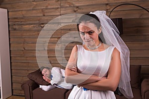 Unhappy bride, sleeping groom on background