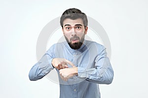 Unhappy business man in blue shirt lost his watch