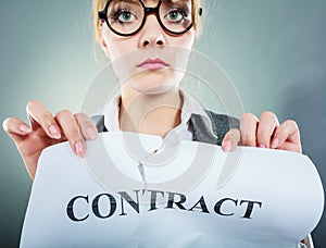 Unhappy business woman showing crumpled contract