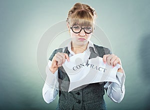 Unhappy business woman showing crumpled contract