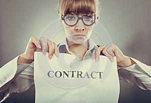 Unhappy business woman showing crumpled contract