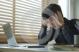 Unhappy businessman covering face with hand, feeling stress, headache, migraine, having problems with project