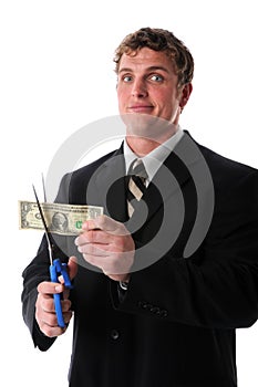 Unhappy Businessman Cutting Dollar Bill