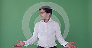 Unhappy businessman looking around over green background