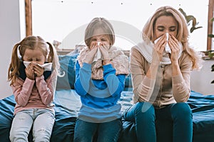 Unhappy cheerless family sneezing photo