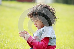 Unhappy child on the grass